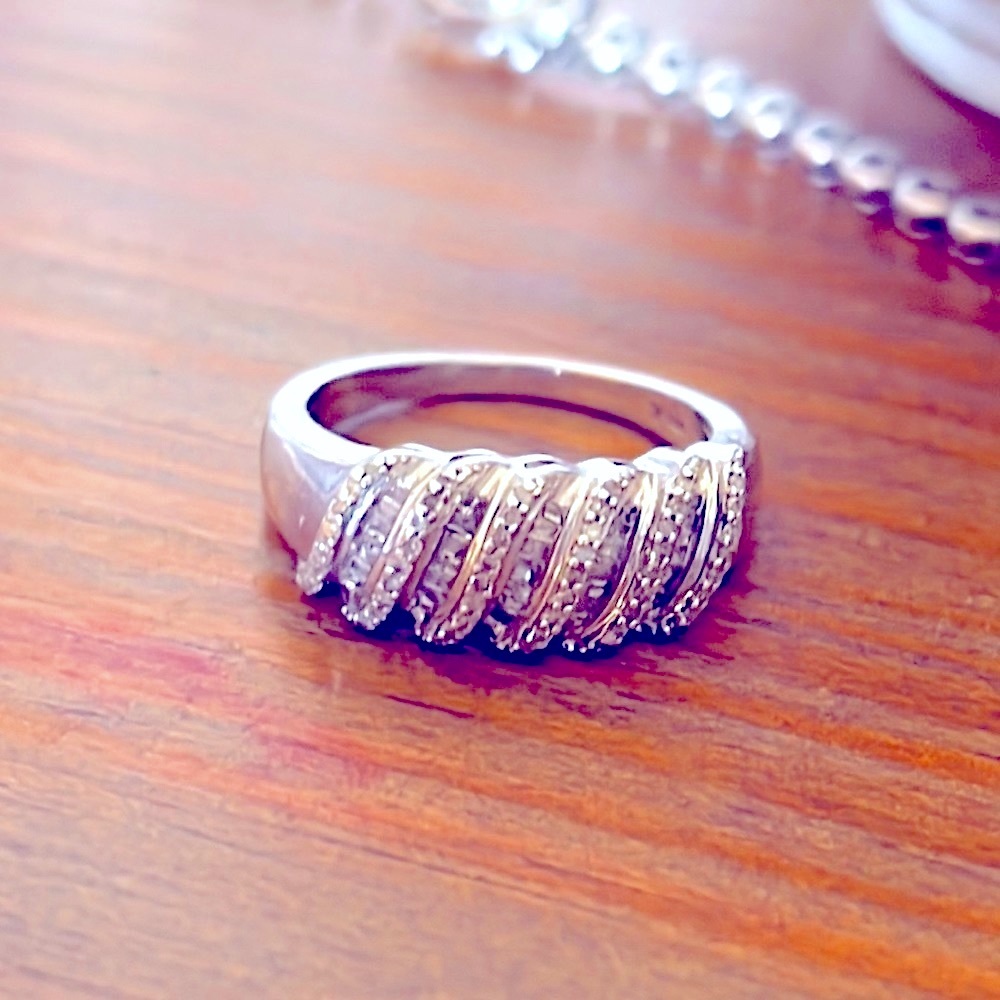 Genuine diamond band ring set in sterling silver.